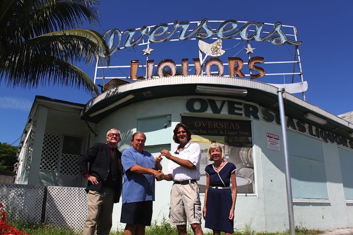 Robert M. Parker, Jr. et al. posing in front of a building - Overseas Pub and Grill