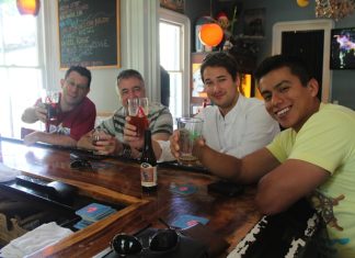 A group of people sitting at a table with wine glasses - Lunch