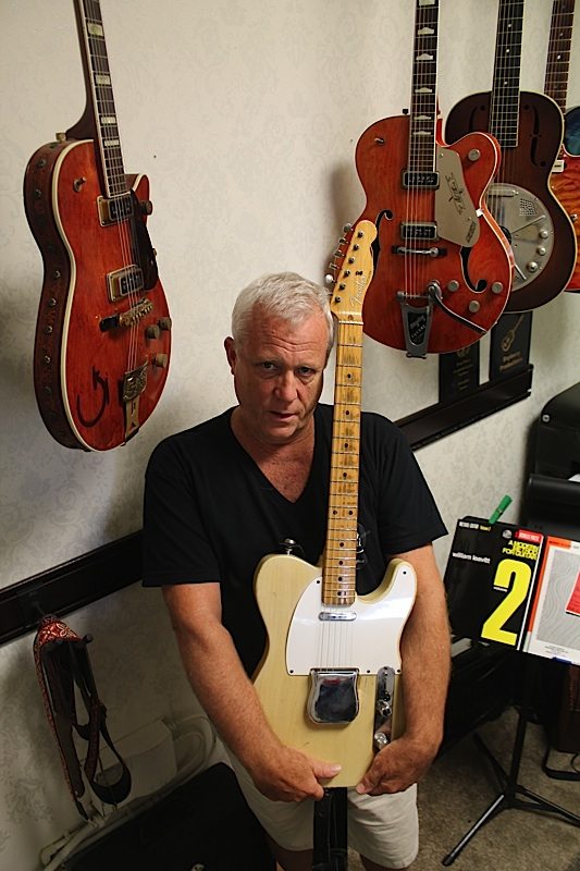 The classics: Daryl Brooke stands with a recently sold 1957 Fender Telecaster, while a1937 National Trovador, a 1955 Gretsch Roundup and a 1957 Chet Atkins Gretsch hang in his office. 