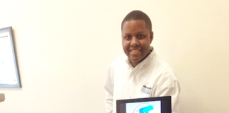 #Technology: IT specialist gives tech tips - A person standing in front of a television - Electronics