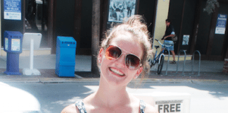 #Question: How would you spend the day with Hemingway? - A woman standing in front of a store - Sunglasses