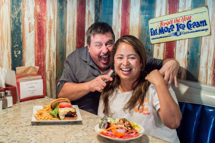 #News: White Street Grill sizzles under new ownership - A man and a woman sitting at a table eating food - Brunch