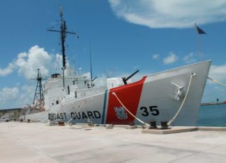 #News: All aboard! (The USCGC Ingham is on display at Truman Annex) - A large ship in the background - Guided missile destroyer