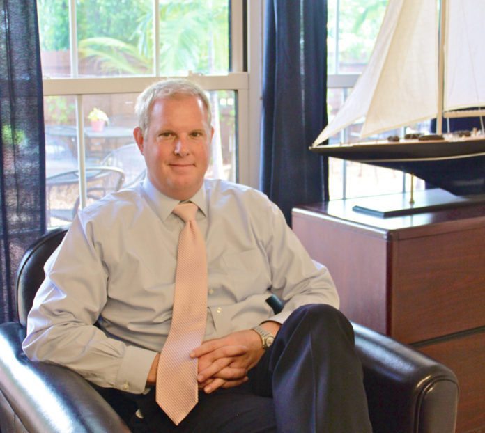 #News: Pete Chapman named chairman of the board - A person sitting in a chair in front of a window - Business