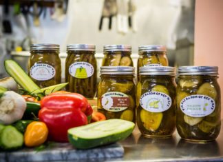 #News: Hand made pickles jar phenomenal flavor - A tray of food on a table - Pickling