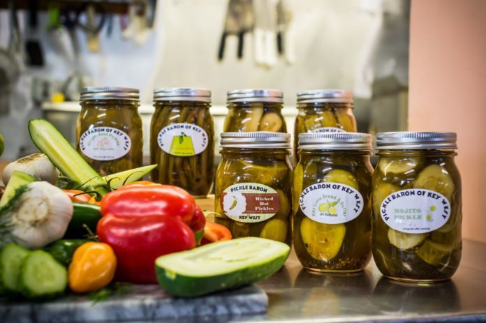 #News: Hand made pickles jar phenomenal flavor - A tray of food on a table - Pickling