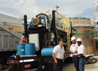 #News: Wastewater plants under new management - A group of people riding on the back of a truck - Transport