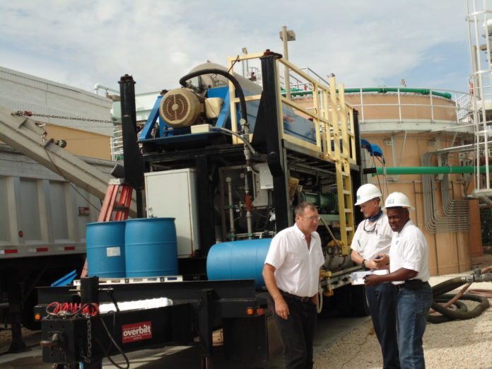 #News: Wastewater plants under new management - A group of people riding on the back of a truck - Transport
