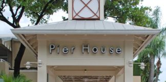 #Events: Pier House goes pink - A group of people standing in front of a sign - Car