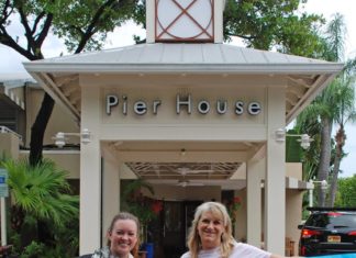 #Events: Pier House goes pink - A group of people standing in front of a sign - Car