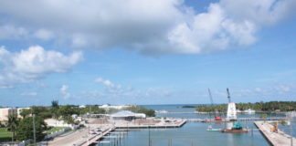 #News: Hyatt to be complete by mid-December - A boat is docked next to a body of water - Marina