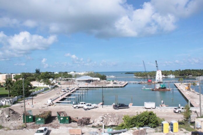 #News: Hyatt to be complete by mid-December - A boat is docked next to a body of water - Marina
