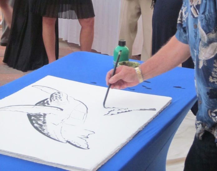 #Events: Wyland coming to art festival - A person holding a fish - Design