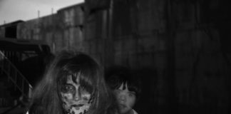 #Events: 13 Scary Years - A woman standing in front of a building - Portrait