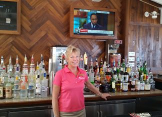 #Libation: Beach Bar and Grille, Pier House Resort - Stephen A. Smith standing next to a bottle of wine - Liquor