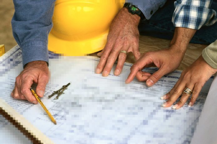 #News: City awards construction bid to Pedro Falcon - A man cutting a piece of paper - Plan