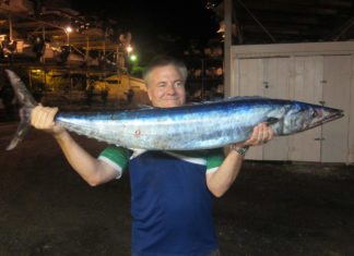 #Column: Try trolling at night - A young man holding a fish - Sardine