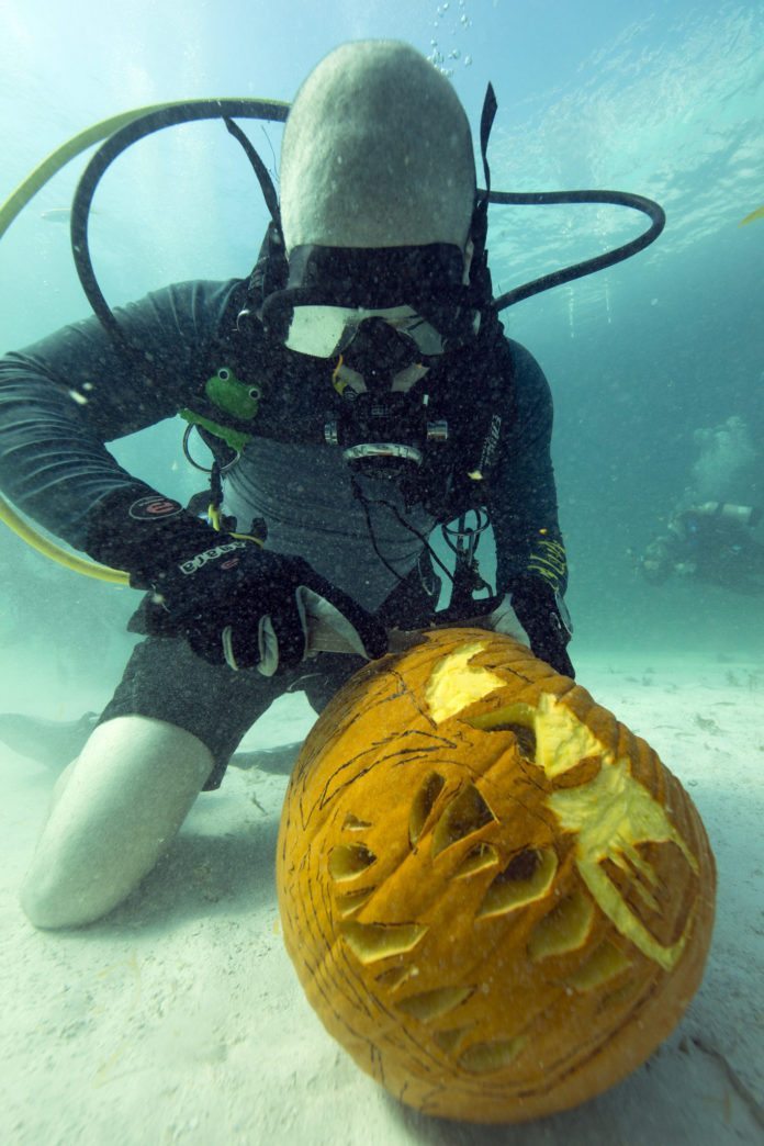 #Events: Divers Carve Pumpkins Underwater in Keys Marine Sanctuary - A person swimming in the water - Tucson