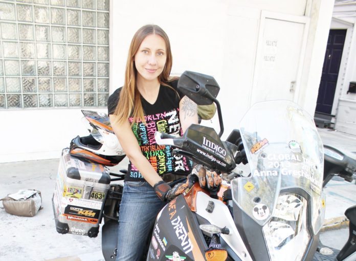 #Feature: International traveler inspires youth - A woman sitting on a motorcycle - Car