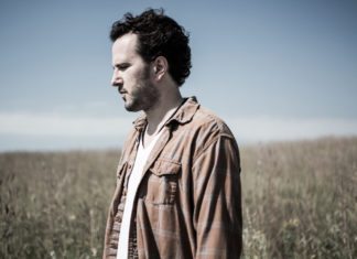 #Music: Mason Jennings plays benefit concert on Stock Island - A man standing on top of a grass covered field - Mason Jennings