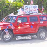 #SeenAroundTown: Marathon celebrates vets - A red and black truck parked in front of a car - Hummer H3