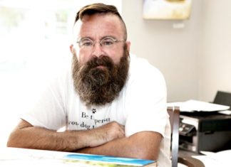 #Arts: ‘Dog Tired’ but driven - A man sitting at a desk - Dog Tired Studio and Gallery