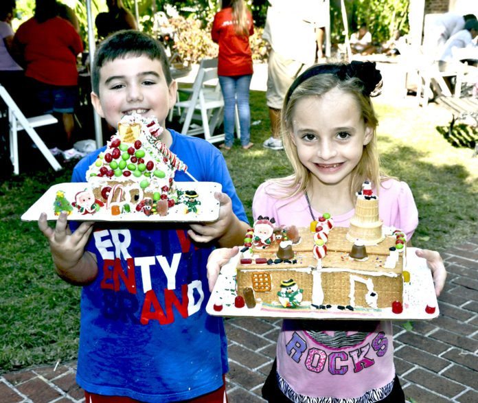 #Events: Free gingerbread house-making party for kids of all ages - A little girl sitting at a table with a birthday cake - DISH