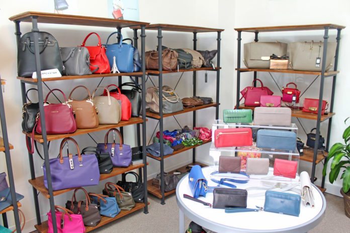 #Shop: New handbag store carries all designs - A room filled with furniture and a table - Handbag