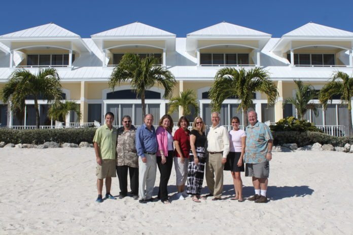 #News: Glunz adds 8 beachfront villas - A group of people standing in front of a building - Glunz Ocean Beach Hotel & Resort