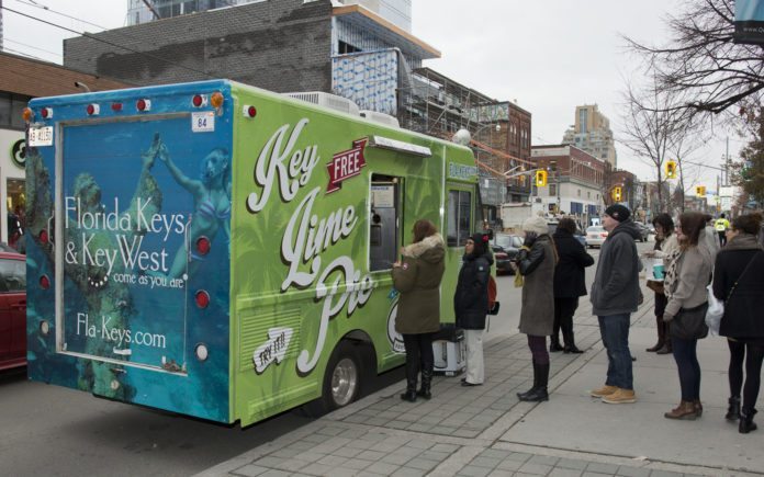 #News: Florida Keys’ Key Lime Pie Truck Rolls Through Canada Region - A group of people standing outside of a food truck - Van