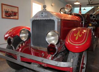 #News: Firehouse Museum preserves rich history - A red and black truck sitting on top of a car - Car