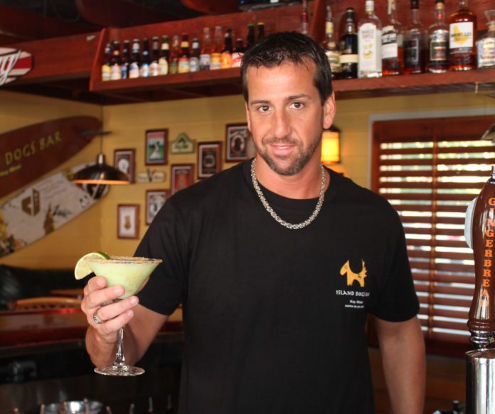 #Libations: Bartender Ben Woodall’s Key Lime Martini - A man holding a glass of beer on a table - Liqueur