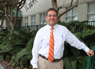 #News: Sam Kaufman to run for Rossi’s seat in Key West Election Oct. 6 - A man wearing a suit and tie standing in front of a building - The Law Offices of Samuel J. Kaufman, P.A.