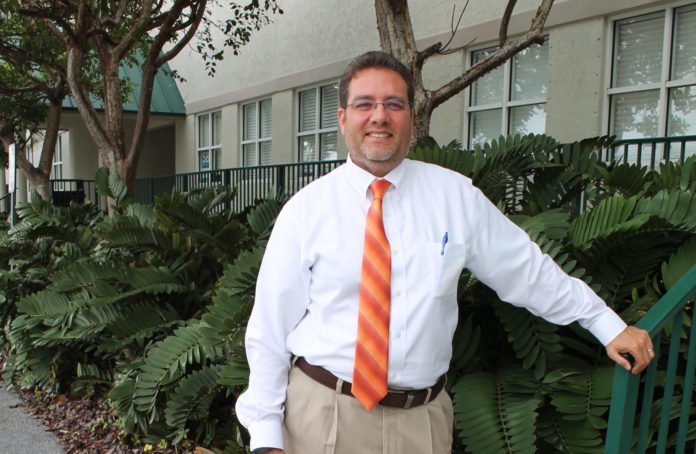 #News: Sam Kaufman to run for Rossi’s seat in Key West Election Oct. 6 - A man wearing a suit and tie standing in front of a building - The Law Offices of Samuel J. Kaufman, P.A.