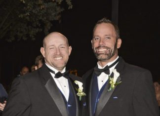 First Same-Sex Wedding Expo Set for Key West - A man wearing a suit and tie - Gourmet Nibbles & Baskets & Flowers