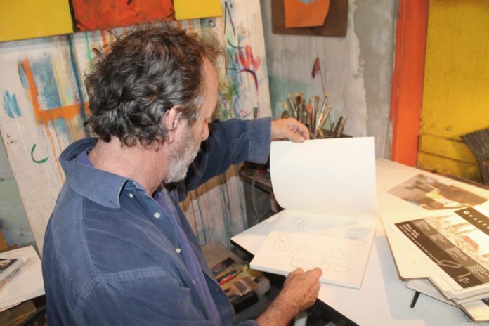 John Martini continues sculpting Key West - A man sitting at a desk - Bahama Village