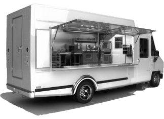 Planning considers food truck law - A white and black truck sitting on the side of a building - Food truck