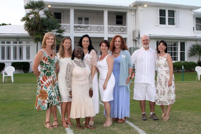 Estate transforms for Womankind event - A group of people posing for a photo in front of a building - Wedding dress