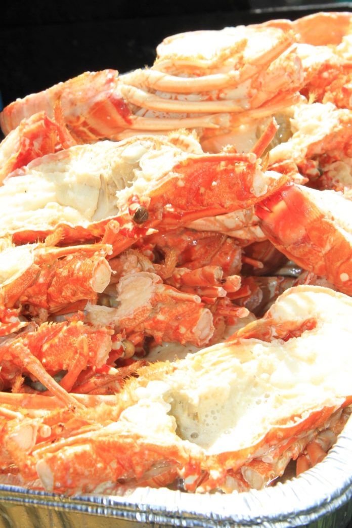 Seafood Fest feeds the crowd – Fishermen and their families benefit from event - A crab on a table - King crab