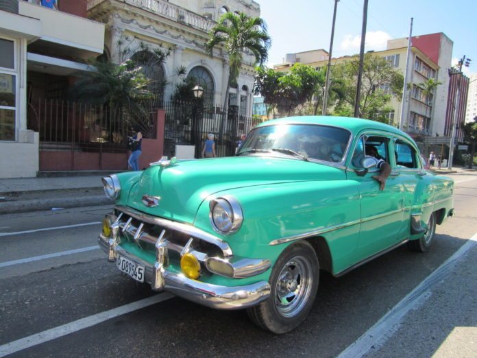 All things Cuba – The Weekly visits the Island ‘A Million Miles Away’ - A green truck parked in front of a blue car on a street - Car