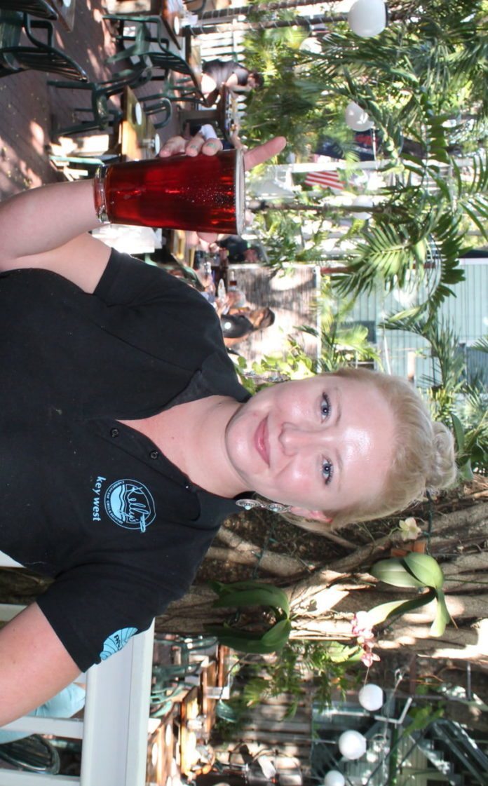 Bartender Sonora Tillman brings out a refreshing Havana Red Ale - A person holding a baby - Florida