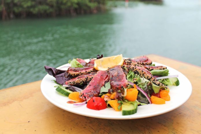 Hidden restaurant with noticeable flavor - A plate of food on a table - Geiger Key Marina