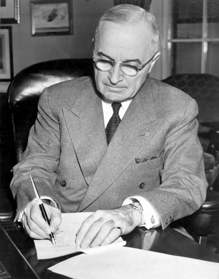 Symposium explores Truman’s health care legacy - Harry S. Truman sitting on a table - Harry S. Truman