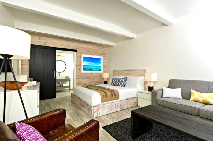 The Gates boasts flair, innovation - A living room filled with furniture and a flat screen tv - The Gates Hotel Key West