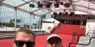 Locals screen movie at Cannes - A man wearing sunglasses and standing in front of a building - Car