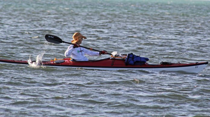 Castaways paddle length of Keys - A man rowing a boat in a body of water - Canoe