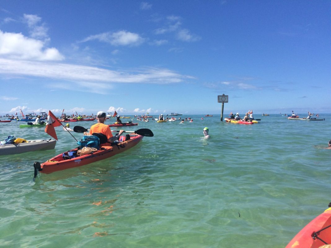 Swimming around Key West … is much easier for the kayaker - A group of people on a boat in the water - Sea kayak