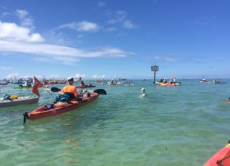 Swimming around Key West … is much easier for the kayaker - A group of people on a boat in the water - Sea kayak