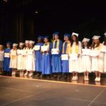 Grads receive awards – Scholarships further seniors’ education goals - A group of people standing in front of a crowd - Student