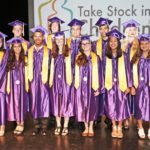 Take Stock students graduate – 50 earn full scholarships - Ruby Jerins et al. posing for the camera - Student